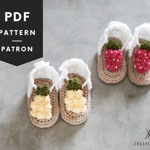 May include: PDF pattern for crocheting baby sandals with pineapple and strawberry designs. The sandals are beige with white crocheted straps and feature 3D fruit embellishments.