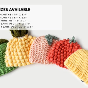May include: Five crocheted hats in different colors and fruit shapes, including green, yellow, pink, red, and yellow. The hats are arranged in a row, with the largest hat on the left and the smallest hat on the right. The hats are all made with a textured stitch. The text "5 SIZES AVAILABLE" is at the top of the image. The text below lists the sizes and dimensions of each hat in inches.