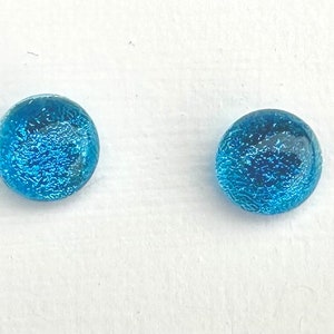 May include: A pair of blue glass earrings with a sparkly finish.
