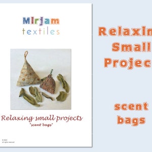 May include: Two small, triangular fabric pouches with a brown and beige pattern. The pouches are filled with dried leaves and are labeled "Relaxing small projects 'scent bags'".
