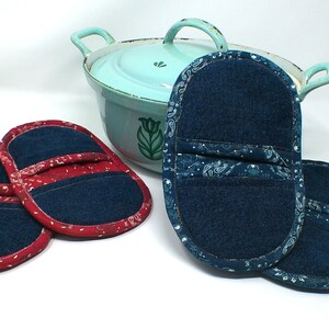 May include: Two pairs of denim pot holders. One pair is red with a paisley pattern and the other pair is blue with a white paisley pattern.