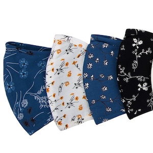 以下が含まれることがあります： 花柄のフェイスマスク7枚セット。マスクは青、白、黒、ベージュなど、さまざまな色があります。各マスクには異なる花柄が施されています。