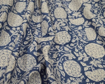 May include: White fabric with a blue floral pattern. The fabric has a repeating pattern of white flowers on a blue background.