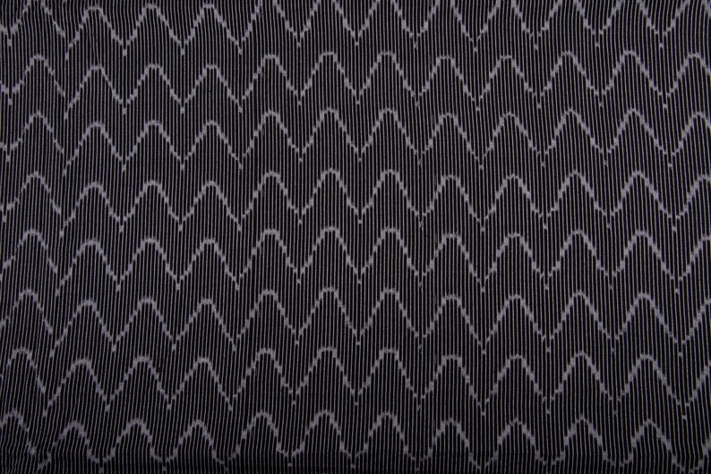 May include: Black fabric with a white wave pattern.