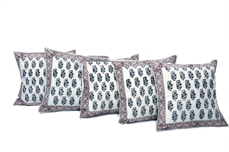 May include: Set of five white cotton pillow covers with a dark blue and maroon paisley print. The pillow covers have a decorative border.