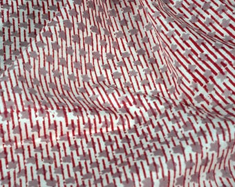 May include: White fabric with a red and gray striped pattern. The pattern features small, gray, flower-like shapes.