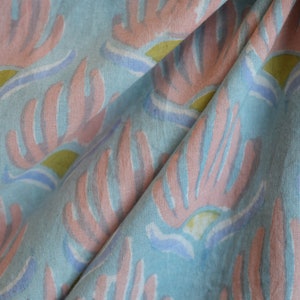 Discover this stunning handmade floral cotton fabric in a pastel blue block print from India,perfect for creating beautiful women's dresses.