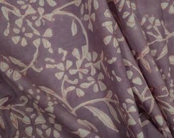 May include: Purple fabric with a white floral pattern. The fabric has a soft, flowing texture.