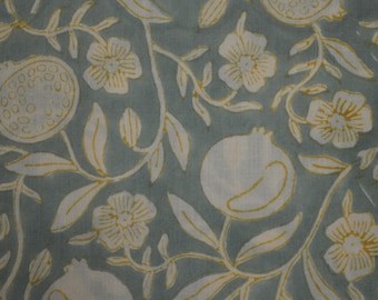 May include: A blue fabric with a white and yellow floral pattern. The pattern features stylized flowers and pomegranates.