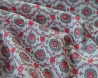 May include: White fabric with a repeating pattern of pink and gray floral designs.