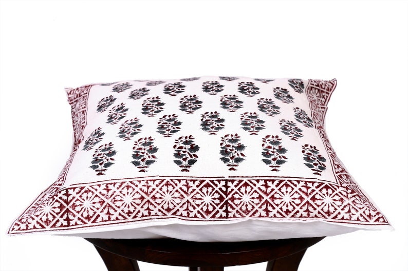 May include: White cotton pillow cover with a burgundy and gray floral print. The pillow cover has a burgundy border with a geometric pattern.