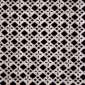 May include: Black and white geometric pattern on a white fabric background. The pattern is made up of small diamonds and squares.
