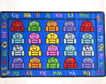 May include: A blue alphabet rug with colorful cartoon chairs featuring different facial expressions. The rug has the letters of the alphabet around the border.