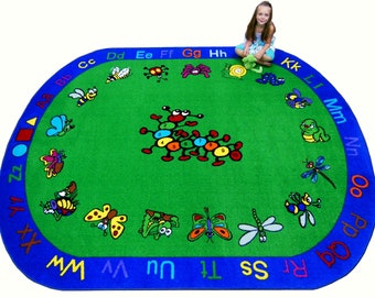 May include: A green and blue alphabet rug with a colorful caterpillar in the center. The rug has a blue border with the letters of the alphabet printed in a circle around the edge. The caterpillar has numbers 1 through 9 on its body.
