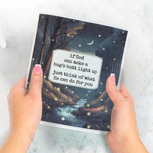 May include: A square, absorbent cloth with a nighttime forest scene and a river. The cloth has the text: "if God can make a bug's butt light up just think of what He can do for you."