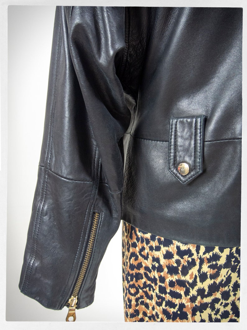 Vintage 80s-90s, new wave style iconic black leather Motorcycle Jacket, designed by ANDREW MARC. The leather is "butter" soft and medium weight. This jacket has a wonderful "new wave" vibe, the shoulders are oversized and padded.