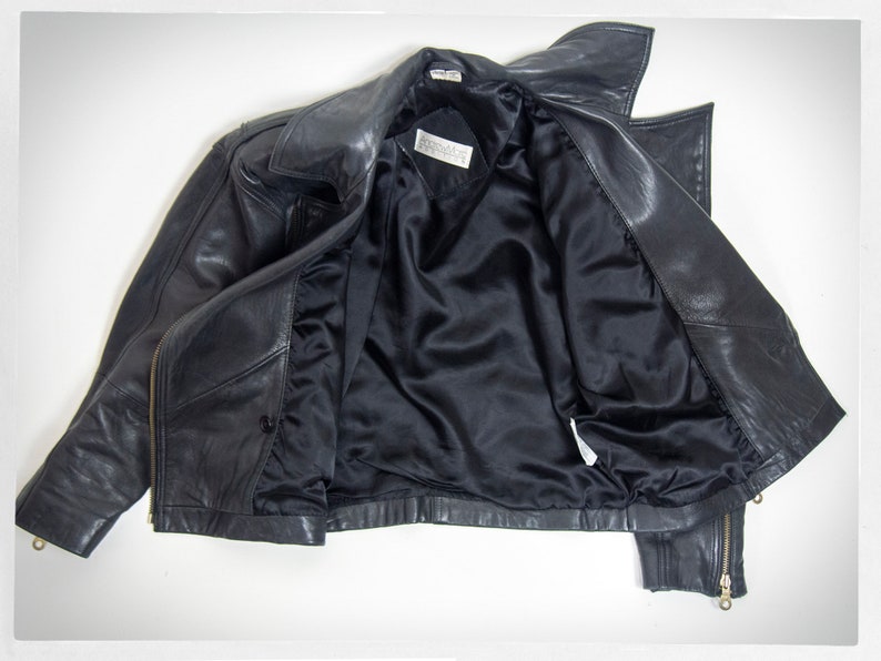 Vintage 80s-90s, new wave style iconic black leather Motorcycle Jacket, designed by ANDREW MARC. The leather is "butter" soft and medium weight. This jacket has a wonderful "new wave" vibe, the shoulders are oversized and padded.