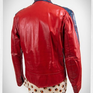 May include: Red leather jacket with blue accents on the collar and sleeves. The jacket has a zipper closure and a stand-up collar.