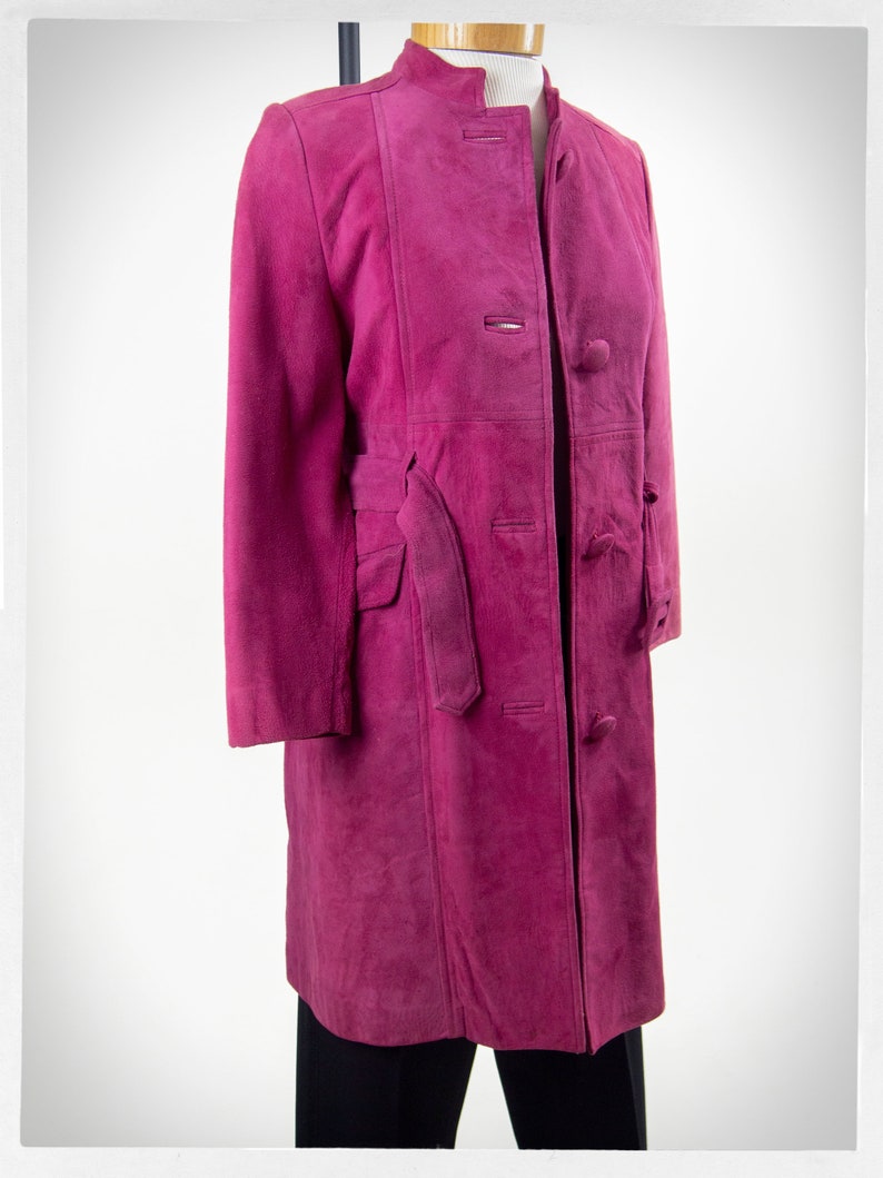 From Oshawa66Vintage.com online consignment store and luxury resale vintage clothing for men and ladies. Vintage 60s-70s mod style dark hot pink kid suede coat with a low profile mandarin collar.