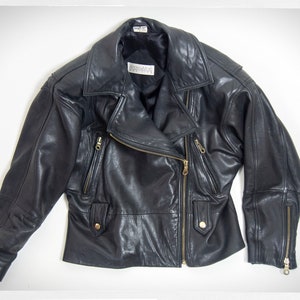 Vintage 80s-90s, new wave style iconic black leather Motorcycle Jacket, designed by ANDREW MARC. The leather is "butter" soft and medium weight. This jacket has a wonderful "new wave" vibe, the shoulders are oversized and padded.