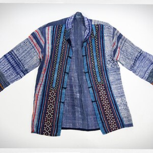 May include: A blue and white patterned jacket with embroidered details. The jacket has a mandarin collar and a front closure with buttons.