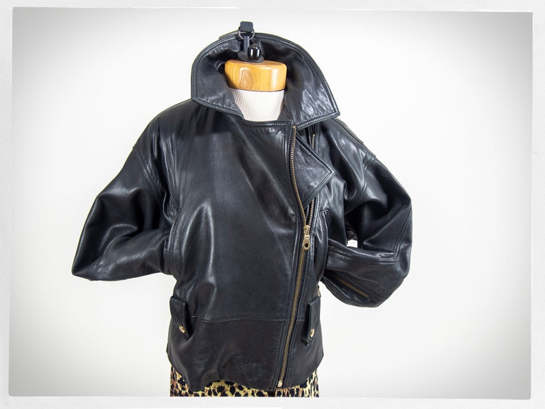 Vintage 80s-90s, new wave style iconic black leather Motorcycle Jacket, designed by ANDREW MARC. The leather is "butter" soft and medium weight. This jacket has a wonderful "new wave" vibe, the shoulders are oversized and padded.