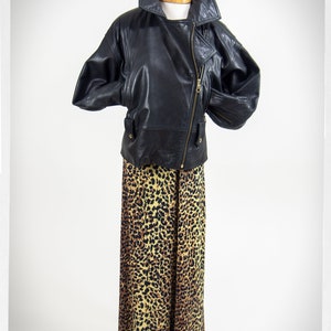 Vintage 80s-90s, new wave style iconic black leather Motorcycle Jacket, designed by ANDREW MARC. The leather is "butter" soft and medium weight. This jacket has a wonderful "new wave" vibe, the shoulders are oversized and padded.