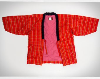 May include: A red and white plaid kimono with a black collar and a pink lining. The kimono has a tie at the waist.