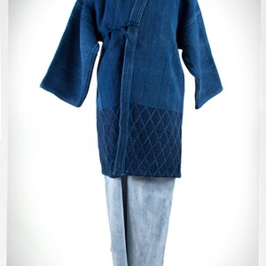 May include: A blue cotton kimono with a diamond pattern on the bottom. The kimono is tied at the waist and has long sleeves.
