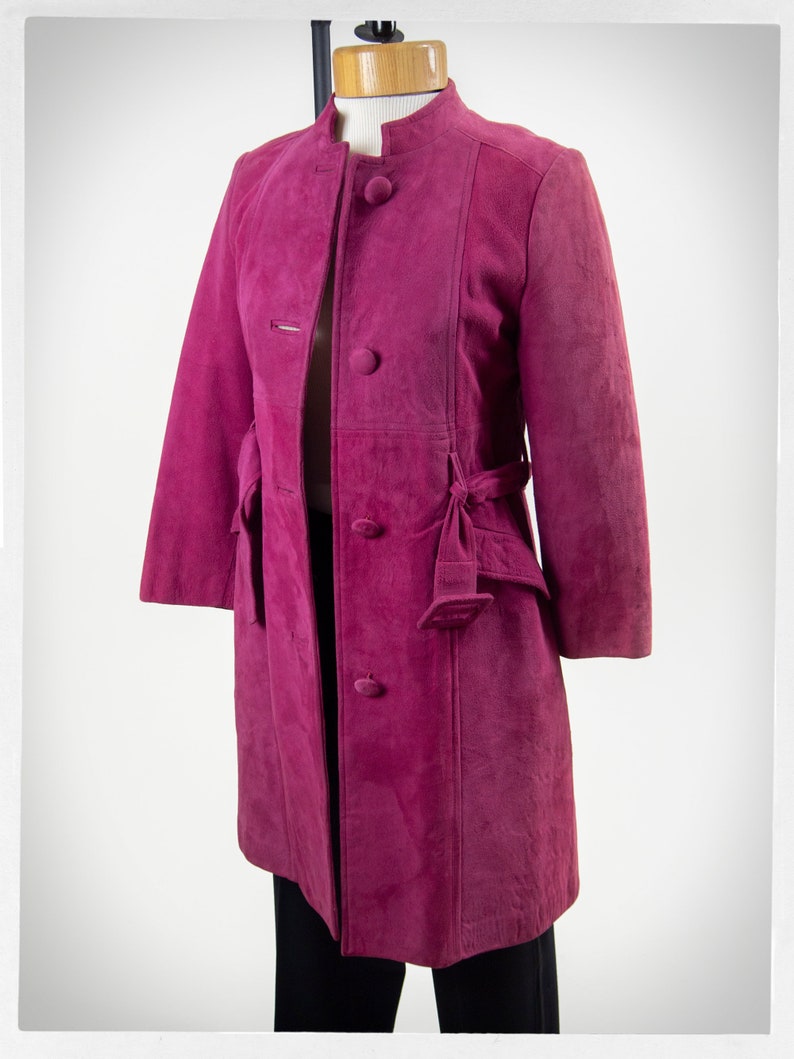 From Oshawa66Vintage.com online consignment store and luxury resale vintage clothing for men and ladies. Vintage 60s-70s mod style dark hot pink kid suede coat with a low profile mandarin collar.