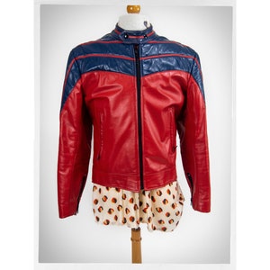 May include: A red leather jacket with blue leather accents. The jacket has a zipper closure and a stand-up collar.