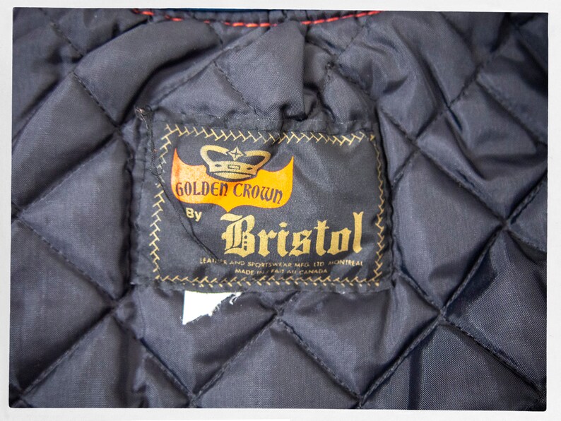 May include: A black quilted jacket with a brown label that reads "Golden Crown by Bristol Leather and Sportswear Mfg. Ltd. Montreal Made in Canada".