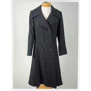 May include: A long, black double-breasted coat with a flared skirt and a large collar.