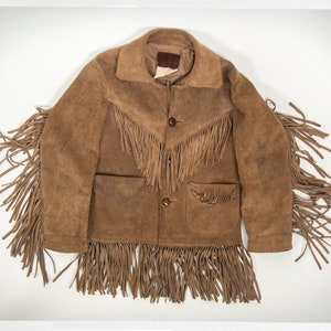 May include: A brown suede jacket with fringe detailing on the sleeves, collar, and hem. The jacket has two pockets and a button closure.
