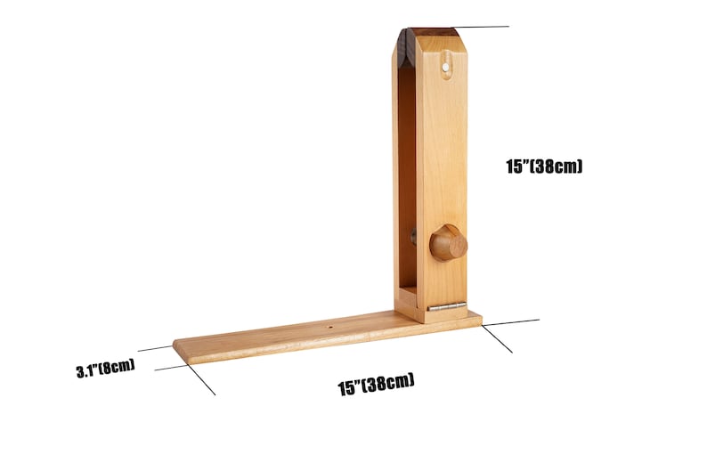 May include: A wooden leathercraft stitching pony, 38cm long and 8cm wide. The tool is made of light-coloured wood and features a vertical clamp and a horizontal base. A wooden knob is visible on the side.
