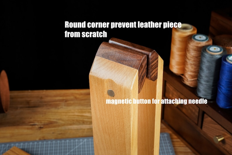 May include: Wooden leathercraft tool with a magnetic button for attaching needles. The tool has round corners to prevent scratching leather pieces. The text on the image says "Round corner prevent leather piece from scratch" and "magnetic button for attaching needle".