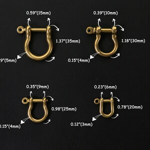 May include: Four gold-coloured metal D-rings of different sizes. The rings are shown against a black background. Measurements in inches and millimetres are provided for each ring.