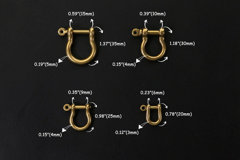 May include: Four gold-coloured metal D-rings of different sizes. The rings are shown against a black background. Measurements in inches and millimetres are provided for each ring.