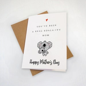 May include: A white card with a red heart and the text "You've been a real koala-ity mom" and a cartoon koala holding a baby koala. The card also says "Happy Mother's Day".