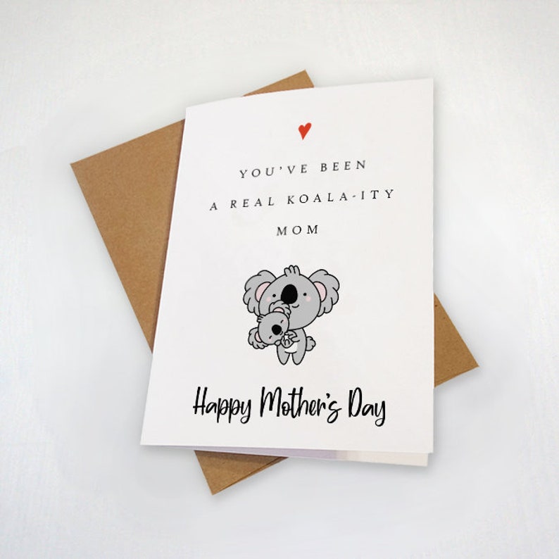 May include: A white card with a red heart and the text "You've been a real koala-ity mom" and a cartoon koala holding a baby koala. The card also says "Happy Mother's Day".