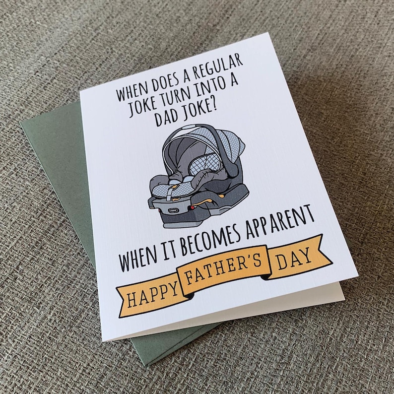 May include: A white card with a black and gray illustration of a baby car seat. The card has the text "WHEN DOES A REGULAR JOKE TURN INTO A DAD JOKE? WHEN IT BECOMES APPARENT HAPPY FATHER'S DAY".