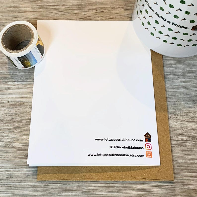 May include: A white card with the text "www.lettucebuildahouse.com", "@lettucebuildahouse", and "www.lettucebuildahouse.etsy.com" printed on it. The card is sitting on a brown envelope.