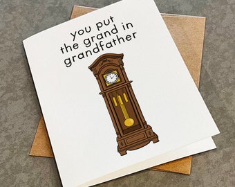 May include: A white card with the text "You put the grand in grandfather" and a cartoon illustration of a grandfather clock.