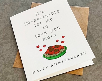 May include: A white greeting card with black text that reads it's im-pasta-ble for me to love you more and HAPPY ANNIVERSARY. The card features a colorful illustration of a green bowl filled with spaghetti, meatballs, and small red hearts.