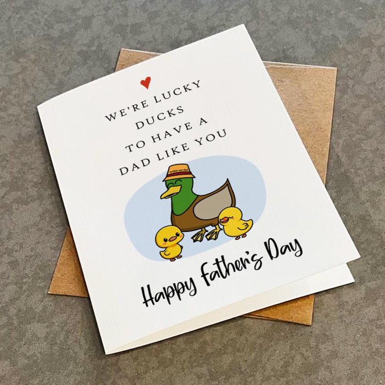 May include: A white card with a red heart, a cartoon duck family, and the text "We're lucky ducks to have a dad like you. Happy Father's Day."