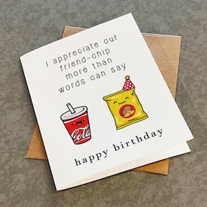 May include: A white card with a birthday message that reads "I appreciate our friend-chip more than words can say happy birthday". The card features a cartoon drawing of a chip bag with a party hat and a soda cup.