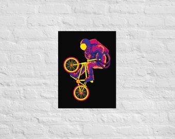 May include: A vibrant poster featuring an astronaut riding a yellow bicycle in a wheelie. The astronaut is wearing a spacesuit with purple, pink, and yellow accents. The background is black, creating a striking contrast. The bicycle has yellow wheels.