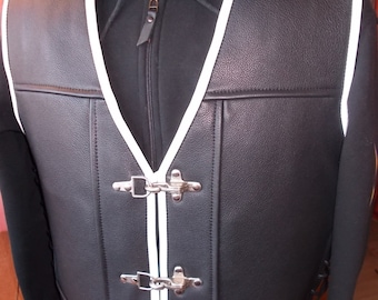 May include: Black leather vest with white piping and silver clasps. The vest has a v-neck and is unzipped.