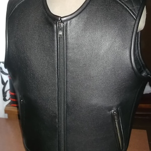 May include: Black leather vest with a zipper closure and a quilted design on the back.