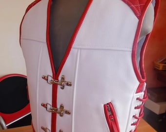 May include: White leather motorcycle vest with red trim and stitching. The vest has a zippered pocket on the left side and a lace-up back. The vest has four silver buckles on the front.